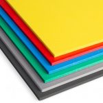 Stack of brightly colored foam core sheets.