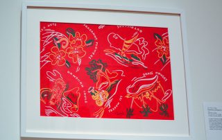 Framed design of palm trees and hibiscus flowers on a red background