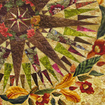 Detail of a quilt with a 64-point compass in the middle